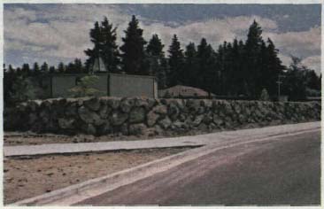 Dry stone used in combination with a berm for noise abatement