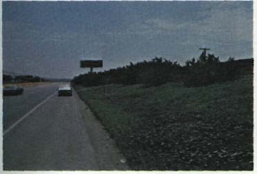 photo of a two lane road with a berm