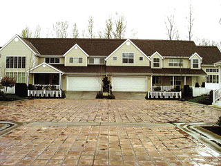 A house with a brick paved driveway