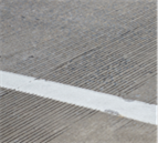 Title: Sample pavement type - Description: A close-up picture illustrating a pavement with transverse tining.