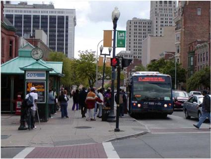 Photo: a busy at an interesection and a crowded street corner.