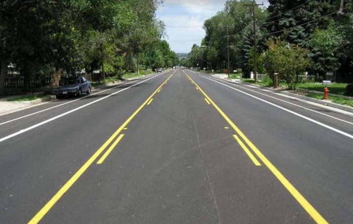 Photo of street with repained, clearer yellow and white lines.