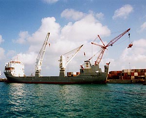 A freighter unloads at a dock.