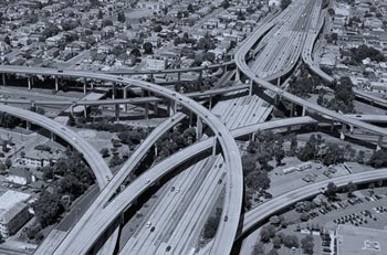 Photo. Aerial view of a complex of elevated interchanges.