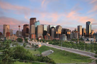 Photo. Calgary skyline at sunset, Alberta, Canada, with parkland in the foreground.
