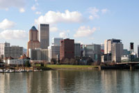 Photo. A view of downtown Portland, Oregon, from southeast in early spring, with the Willamette River in the foreground.