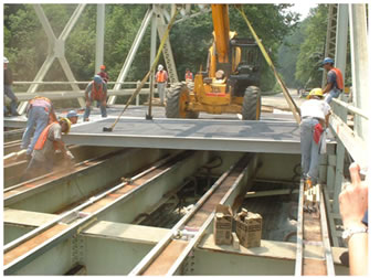 Photo Of Placement of Fiber Reinforced Polymer (FRP) Deck Panels On Steel Girders.