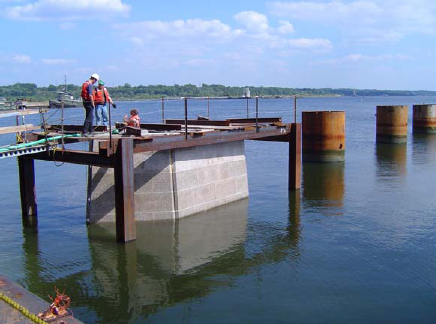 This figure shows a photo of the precast concrete pier box cofferdam used on the Providence River Bridge.