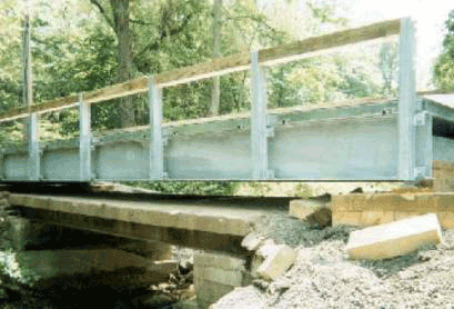 Picture showing a deteriorated bridge with prefabricated longitudinal steel beams.