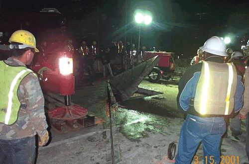 Photo showing the the removal of a cut section of the existing concrete deck of the James River Bridge.