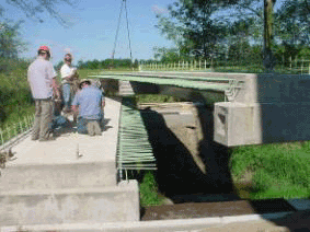 Picture showing the placement of a unit of the cold formed steel box bridge system in place.