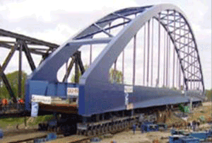 Picture showing a large steel arch bridge during transportation.