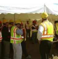 Researchers gathered under a canopy