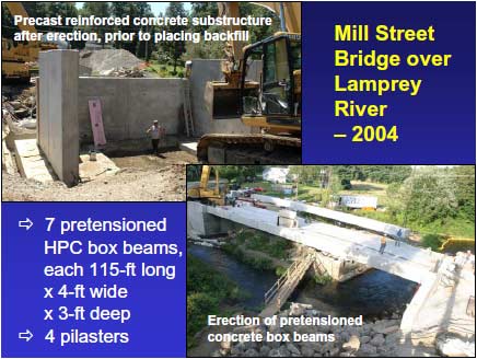 Mill Street Bridge during construction. The precast concrete abutment segments are in place at one end of the bridge. Construction workers are preparing the area behind the abutment for backfill placement.