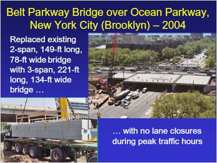 Belt Parkway Bridge during construction. A superstructure segment that was trucked to the site is being erected with a crane. The existing three lanes of traffic in each direction are being maintained with the addition of a temporary bridge at this construction stage.