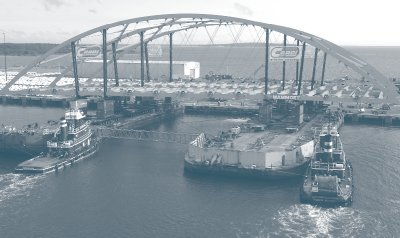 SMPTs move RIDOT Providence River bridge span onto barges at staging area from the left side.