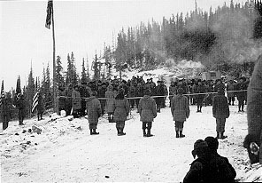 Photo: A ribbon separates Royal Canadian Mounted Police and U.S. Army troops at the dedication of the Alaska Highway.