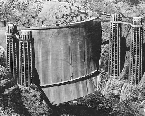 Black and white aerial photograph of the upstream face of the Hoover Dam.