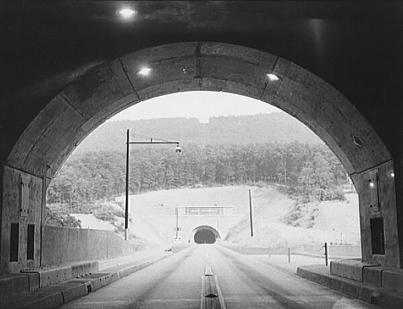 Black and white photograph looking through the twin tunnels on the Pennsylvania Turnpike.