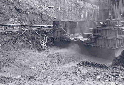 Black and white photograph of men working on the construction of the Eisenhower Memorial Tunnel.