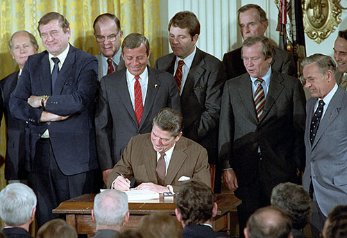 Commemorative photograph of President Reagan signing the Surface Transportation Assistance Act (STAA).