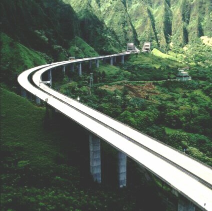 Aerial photograph of Interstate H‐3 as it curves through Hawaii's rugged landscape.