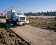 large truck driving on a temporary road surface mat