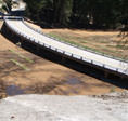 250-foot 7-span concrete bridge constructed to replace the restrictive dual 36-inch pipe culverts placed during the original construction, which would reestablish water flow by bridging the surrounding meadows.