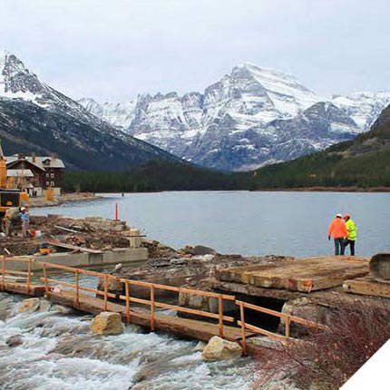 Repair and rebuilding of Swiftcurrent Bridge while retaining the crossing's historical integrity by integrating a stone masonry veneer and recreating the historic style of the bridge's pedestrian rail.