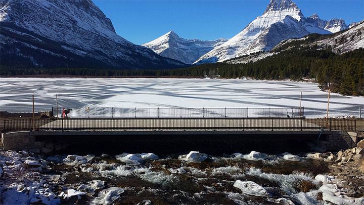 Repair and rebuilding of Swiftcurrent Bridge while retaining the crossing's historical integrity by integrating a stone masonry veneer and recreating the historic style of the bridge's pedestrian rail.