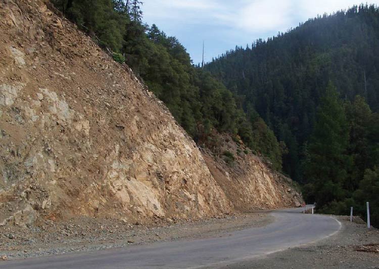 Photo. Drainage intercept layback cut into a slope, Hyampom Road, California.