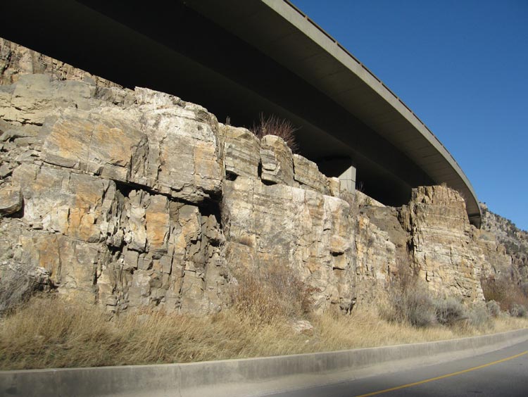 Photo. Staining on the completed cut slope used to create a natural-looking rock face.