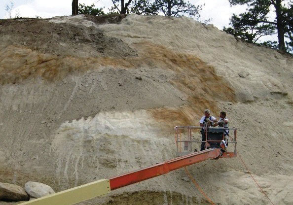 Photo. Application of stain to a newly constructed rock slope.