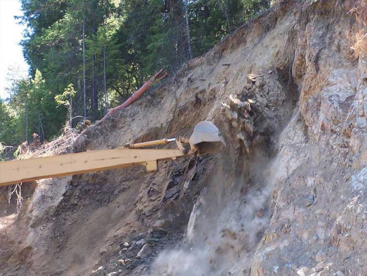 Figure 40. Photo. Using a long-reach excavator for mechanical scaling.