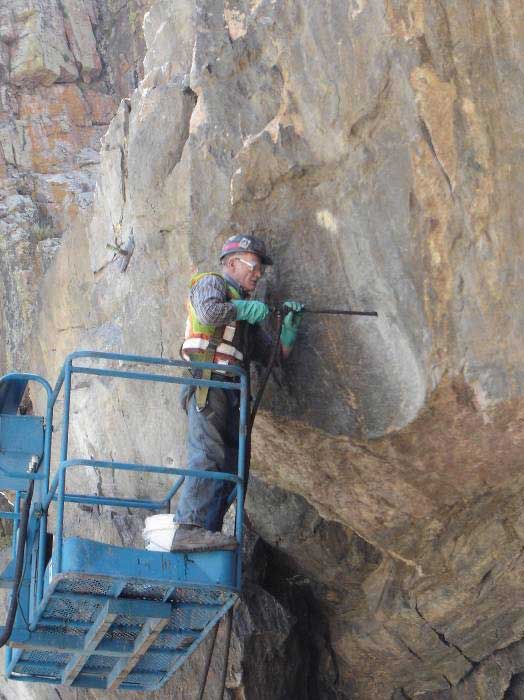 Figure 48. Photo. Installation of polyurethane resin from man lift, Poudre Canyon, Colorado.