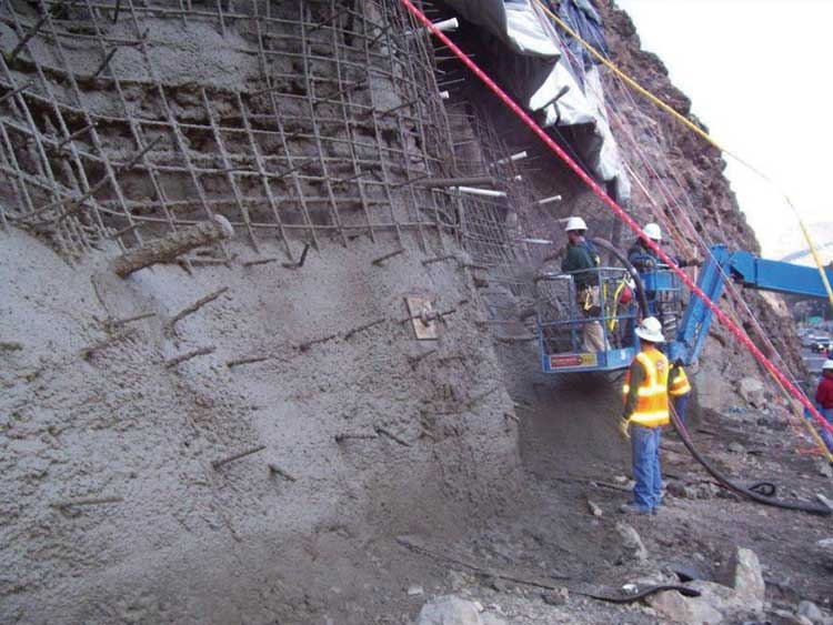 Figure 53. Photo. Application of the first layer of structural shotcrete.