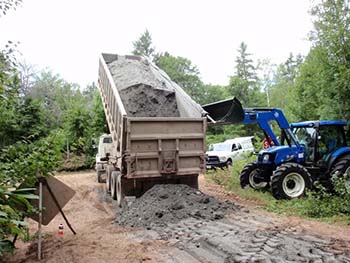 Dumptruck dropping a pile of ash.