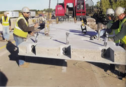 Photograph of installation of a pre-cast concrete roadway panel.