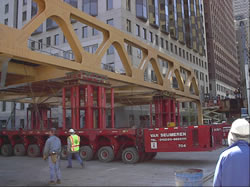 Photograph of a "roll in" bridge being moved by a Self Propelled Modular Transport.