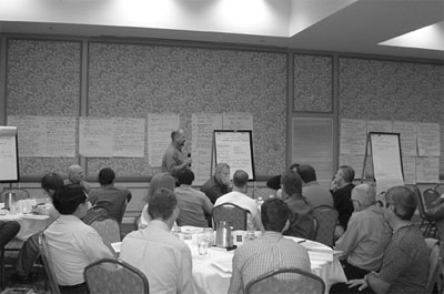 Figure 4. Photo. Participants at conference. Participants engage with speaker during the first National Maintenance Quality Assurance Peer Exchange Conference.