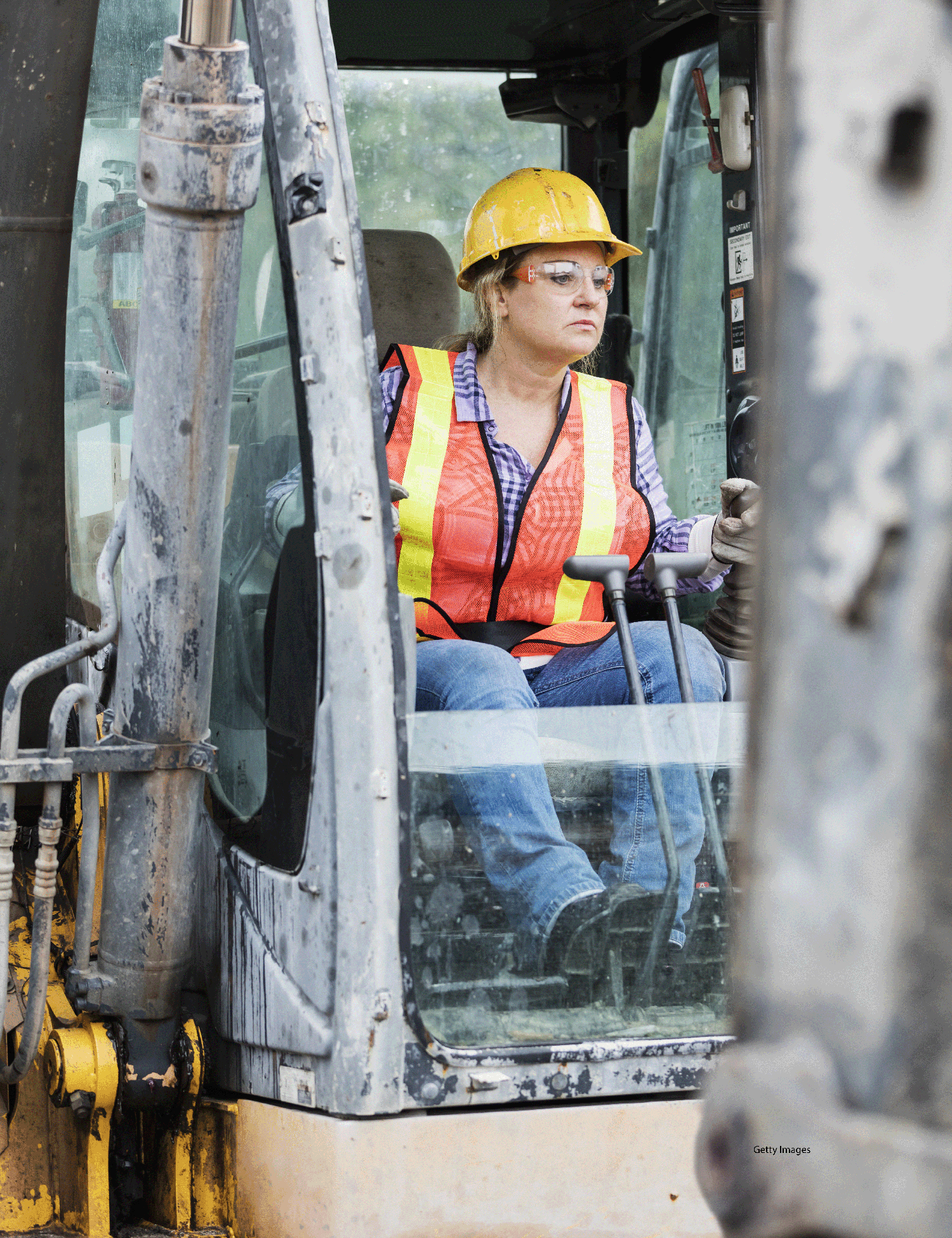A woman operating construction equipment is shown.