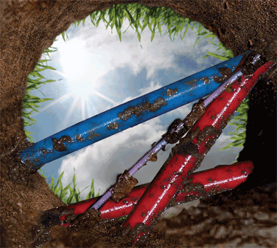 This picture, which is on the cover of the brochure, shows an upward look from the bottom of a test hole at utility facilities that have been exposed using nondestructive vacuum excavation as part of the subsurface utility engineering process.