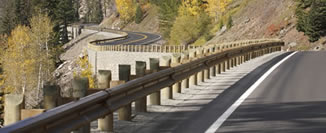 Curvilinear alignment and retaining walls reduce the impact to the surrounding slopes and help the East Entrance Road remain true to its historic alignment. Weatherized steel guardrail blends into the natural colors present along the route.