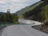 Photo of the top section of the bifurcated freeway. The roadway curves along the contours of the hillside.