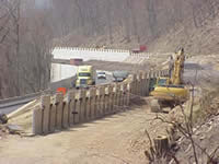Photo showing the construction of the curving MSE walls that will separate the upper and lower portions of the bifurcated freeway.