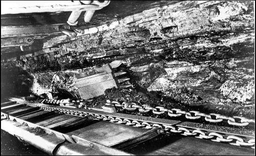 Photo: Longwall coal face ripper. The overlying strata are of varying thickness and rock types (photo courtesy of David Young).