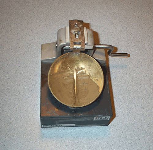 Close up photo of liquid limit test device referenced in Table 5-21.
