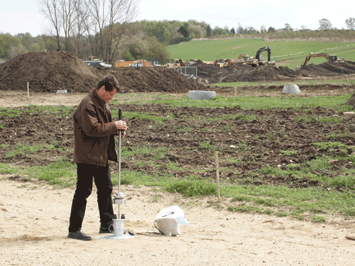 Photo showing a person using a lightweight Falling Weight Deflectometer for field control.