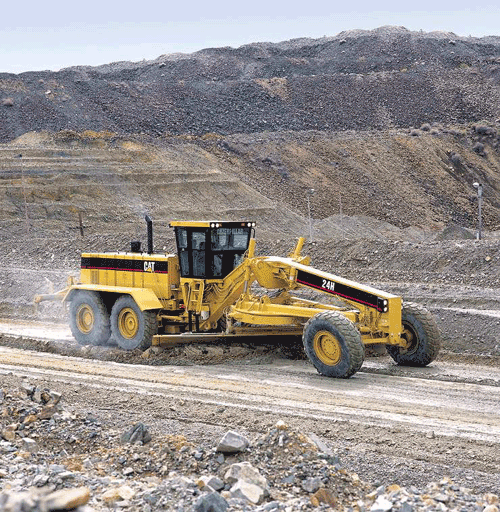 Close up photo of a motor-grader used to spread borrow materials.
