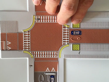 Photo of fingers on a tactile map of a shared street.